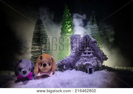 Toy Dog - A Symbol Of The New Year Under The Snow Against The Background Of Fir Branches. Toy's Dog 