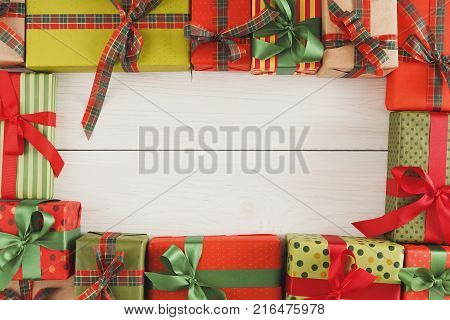 Christmas Gift boxes background top view copy space. Presents in craft and colored paper decorated with ribbon bows.