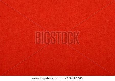 Scarlet red colorful felt soft rough textile material background texture close up