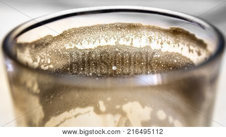 Macro texture of empty glass of Cortado - Spanish coffee with milk,
