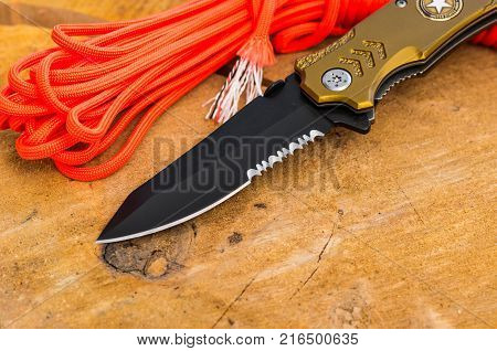 Black knife blade with a serritorial blade.