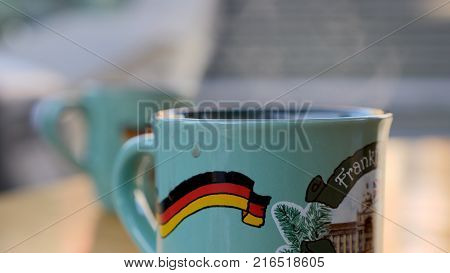 Steaming Cup of Hot Mulled Gluehwein at German Market in British Town.