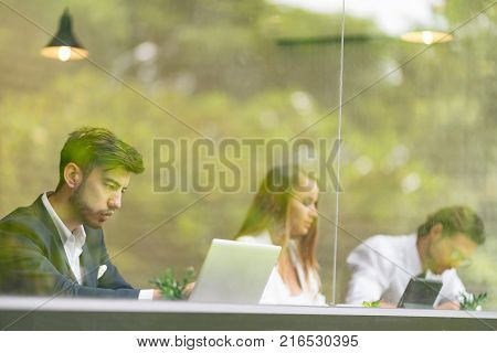 Successful Confident Three Business People Using Tablet Computer in Opposite Modern Glass Grand office. Dream Working Team on New Startup Project.