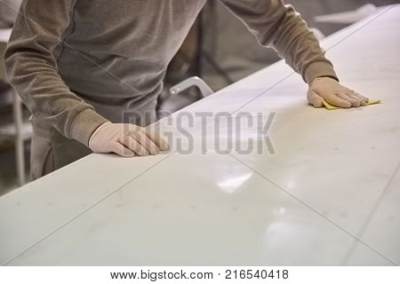 Man is cleaning white plate. Plane cleaning.