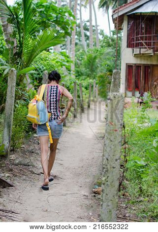 Lady Traveler walking down the narrow path