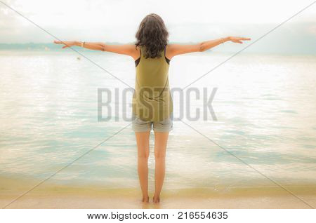 Girl With Open Arms doing Flying Gesture on a Beach
