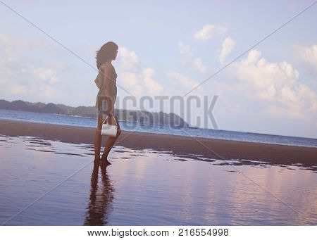 Girl Standing in Water on a Beach