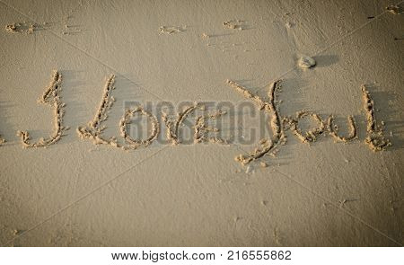 Love You Writing on Sand by using hand