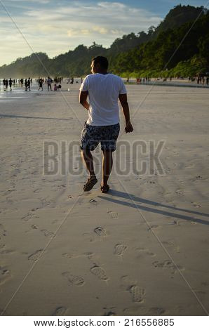 Man doing a funny walk on the beach