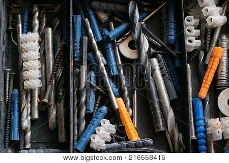 Set of tools and different contraptions in a plastic box.