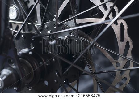 disk brake of the mountain bicycle on a black background a close up