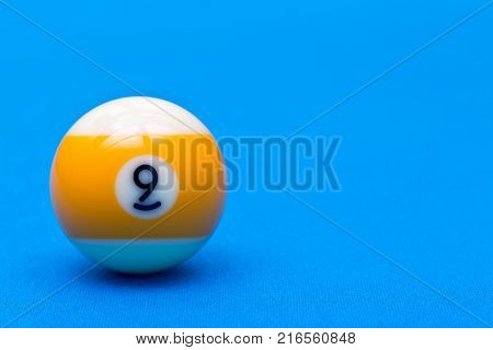 Billiard pool game nine ball on billiard table with blue cloth copy space