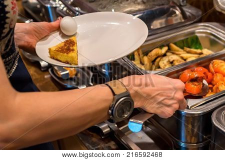 Close up metal containers with prepared dishes for buffet breakfast in hotel