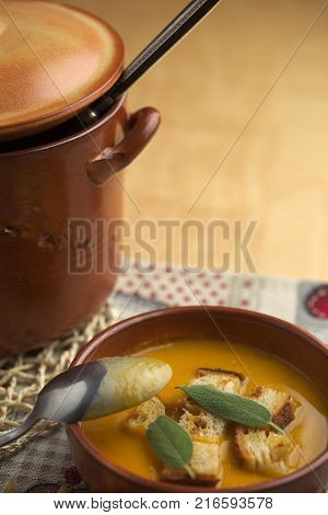 Pumpkin soup and leeks, with sage leaves.