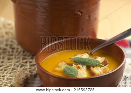Pumpkin soup and leeks, with sage leaves.