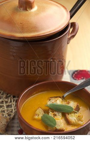 Pumpkin soup and leeks, with sage leaves.
