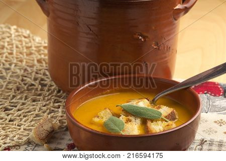 Pumpkin soup and leeks, with sage leaves.