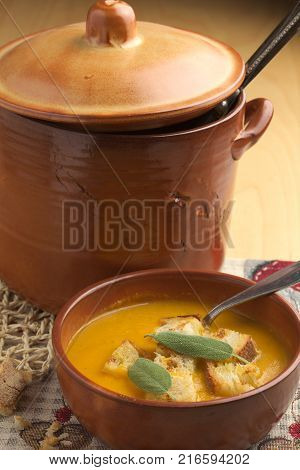 Pumpkin soup and leeks, with sage leaves.