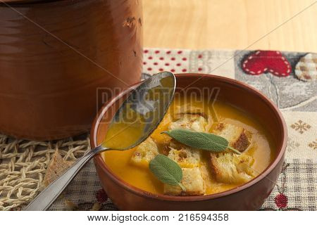 Pumpkin soup and leeks, with sage leaves.