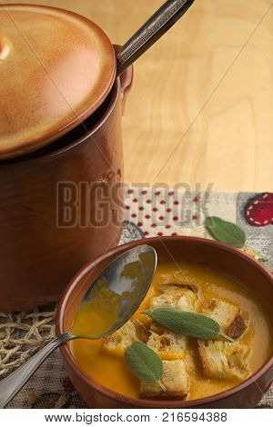 Pumpkin soup and leeks, with sage leaves.