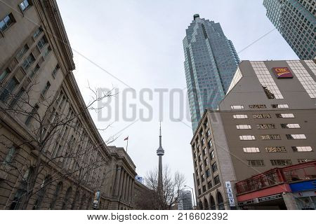 TORONTO CANADA - DECEMBER 312016: View of the Canadian National Tower (CN Tower) seen from Union Station in Toronto Ontario. These two buildings are among the most iconic of the city