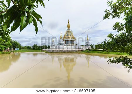 Magnificent Wat Thung Setthi (The Great Jewel Chedi of the three worlds) in beautiful day and reflection Khon Kaen Thailand