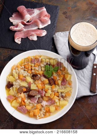 Traditional Irish dish Dublin coddle with sausages and beer on a table