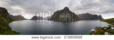Aerial view of a Kirkefjord, Mount Olstind and Reine fishing village on Lofoten islands in Norway