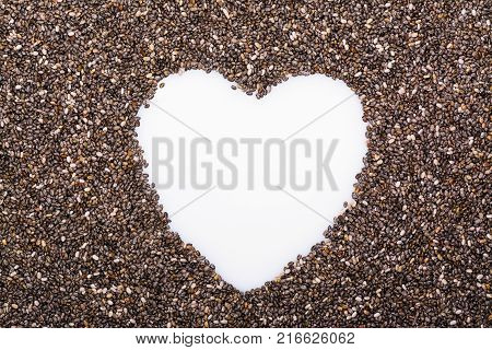 Chia seeds background with copy space in shape of heart. Healthy eating concept