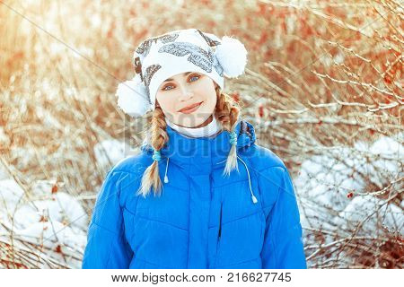 Happy trendy blonde posing outdoors in the woods