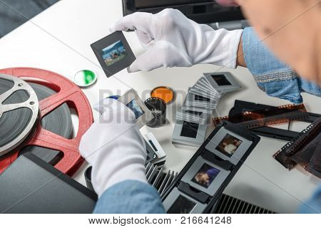 a woman photographer looking at film slide
