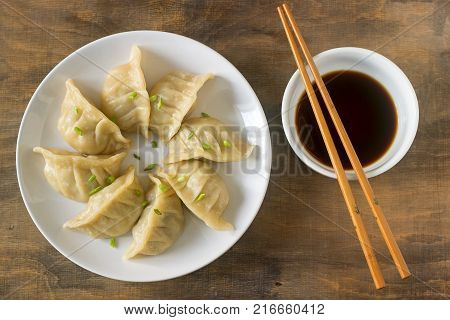 Eight Boiled Or Fried Jiaozi Or Gedza Served With Soy Sauce.