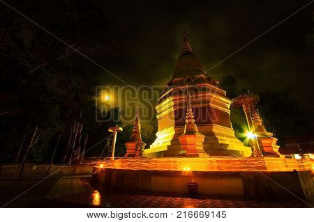 phopphra thailand - May 102017 : a Buddhist ceremony where people walk with lighted candles in hand around a temple.