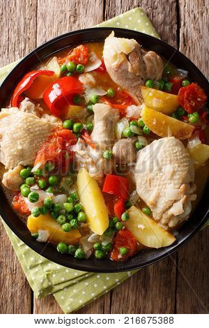 Pieces Of Chicken Stew With Potatoes, Peppers, Tomatoes, Peas And Onions Close-up. Vertical Top View