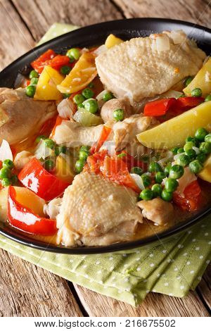Pieces Of Chicken Stew With Potatoes, Peppers, Tomatoes, Peas And Onions Close-up. Vertical Top View