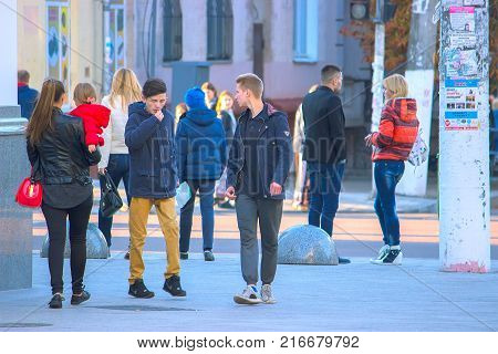 Zhytomyr Ukraine - October 19 2015: people are communicating on the street near bus stop