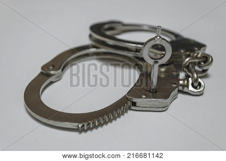 Police steel handcuffs with the key inside.