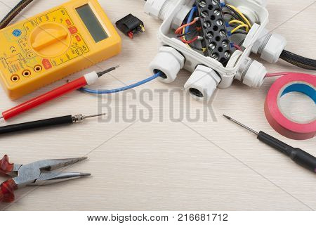 Different electrical tools on wooden background. Copy space for text.