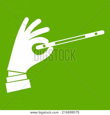 Magician hand with a magic wand icon white isolated on green background. Vector illustration