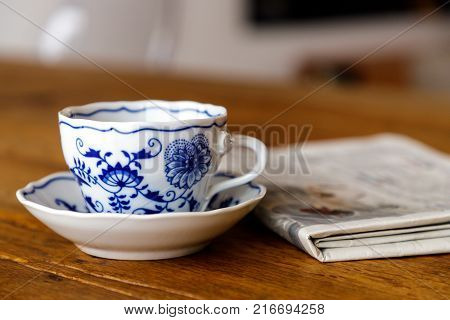 Decoration coffee cup in wood table with Newspaper.