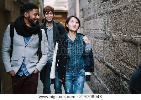Multi-ethnic group of friends having fun in Paris, Latin Quarter, near Notre Dame Cathedral.