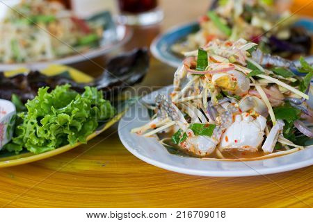 SOM-TAM Thai delicious raw papaya salad with unique taste hot and spicy this dish with tomato and crab. Papaya salad with red chili.