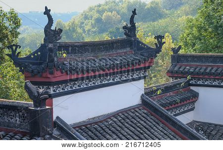 Wuhan Hubei Province China - Nov 6 2017: The roof of China's hubei province wuhan to old palace Can be see double deck bridge at Wuhan Yangtze River Bridgebuilt in 1957. It's famous for travel. Many people come to relax at evening time.