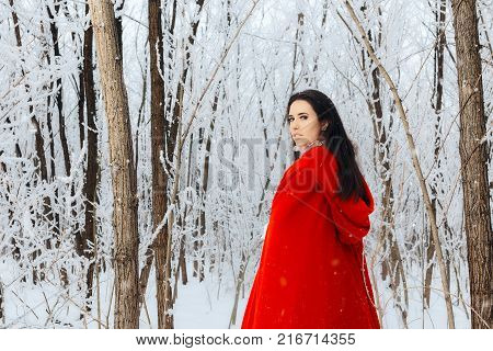 Beautiful Red Riding Hood Princess in Magic Winter Forest