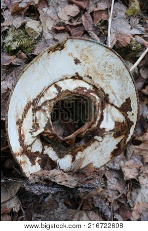 old rusty crumpled plafond for electric street lighting of the Soviet era thrown in the woods