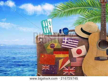 Concept of summer traveling with old suitcase and guitar