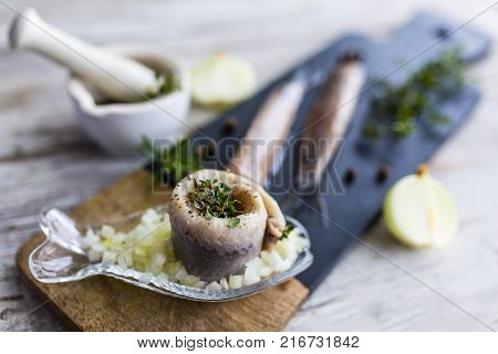 Delicious wrapped herring with fresh herbs and onions.