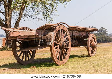 Settlers wood ox wagon closeup of ancient travel vehicle for new pastures.
