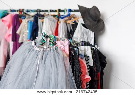 Many ladies evening gown long dresses on hanger in the dress rent shop for photo session. Dresses rental concept. Selective focus. Ball gown rental concept
