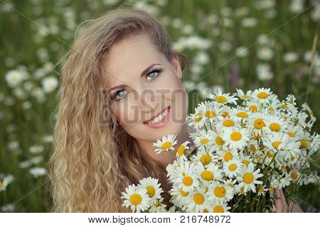 Beautiful Lady With Cute Daughter On Camomile Field Full Of Flowers